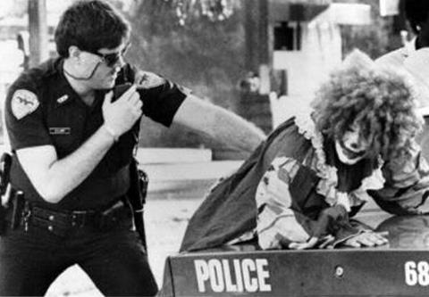 a cop arresting a clown